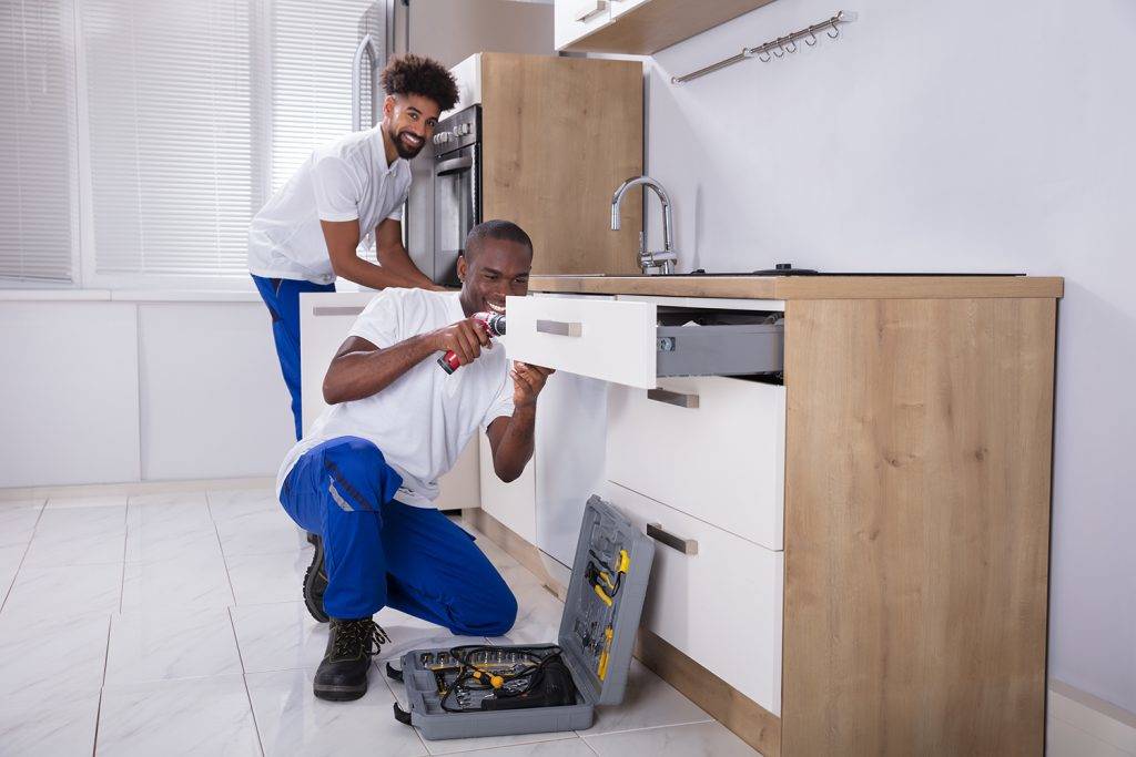 Two Plumbers Installing Kitchen